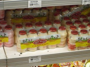 A shelf full of bottles of Yakult